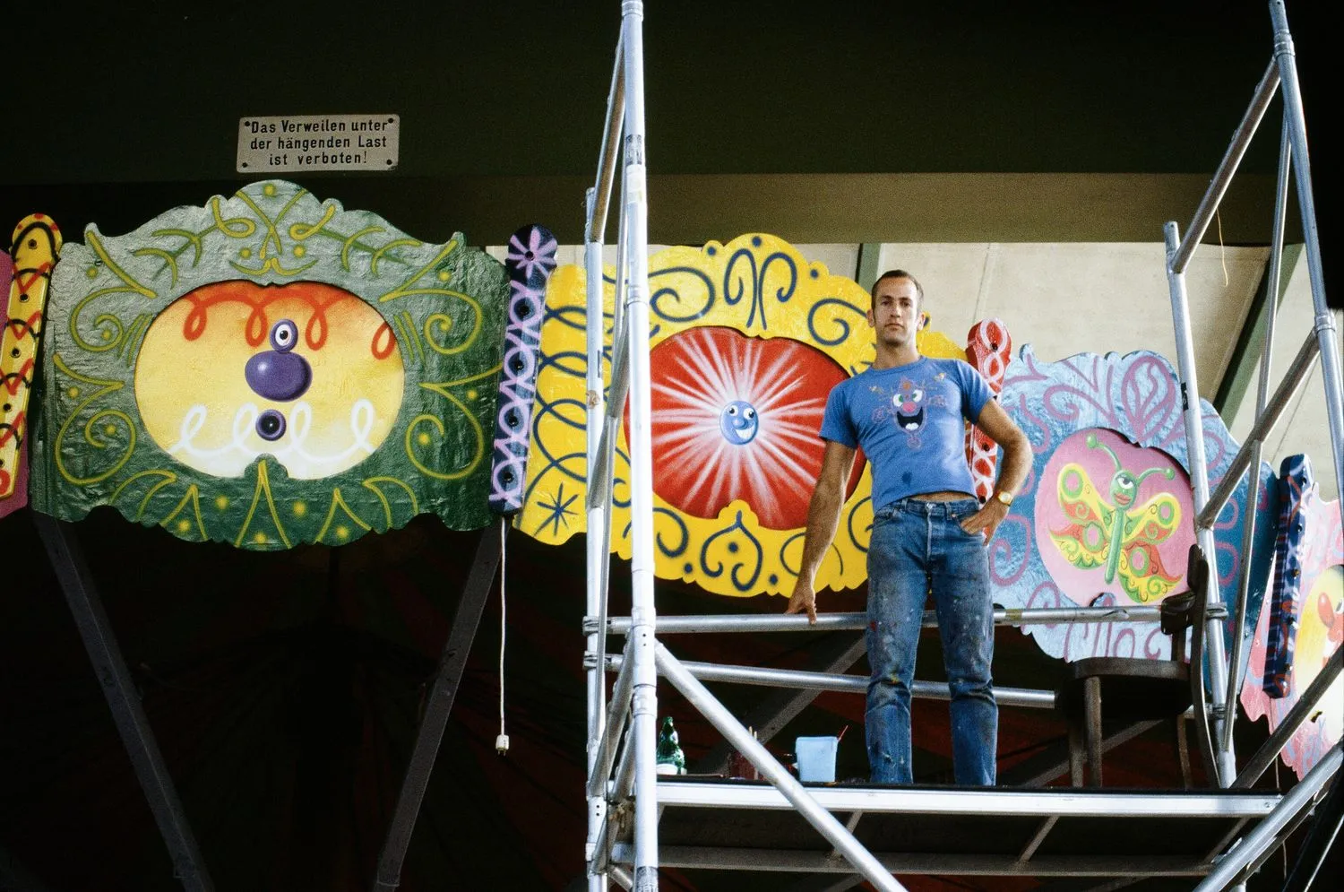 Kenny Scharf with his painted chair swing ride. Andre Heller New York iteration is on view at the Shed.