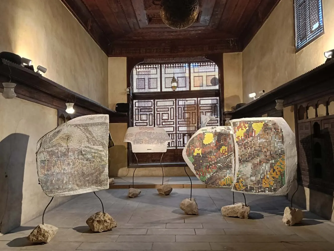 Suat Ögüt, Echoes of Silent Hums, 2024. Mosaic on car parts, metal stands, audio. Installation of variable dimensions. Something Else IV: Cairo Off-Biennale, Prelude: The Fortress of Forked Paths. (9-22 February 2025)