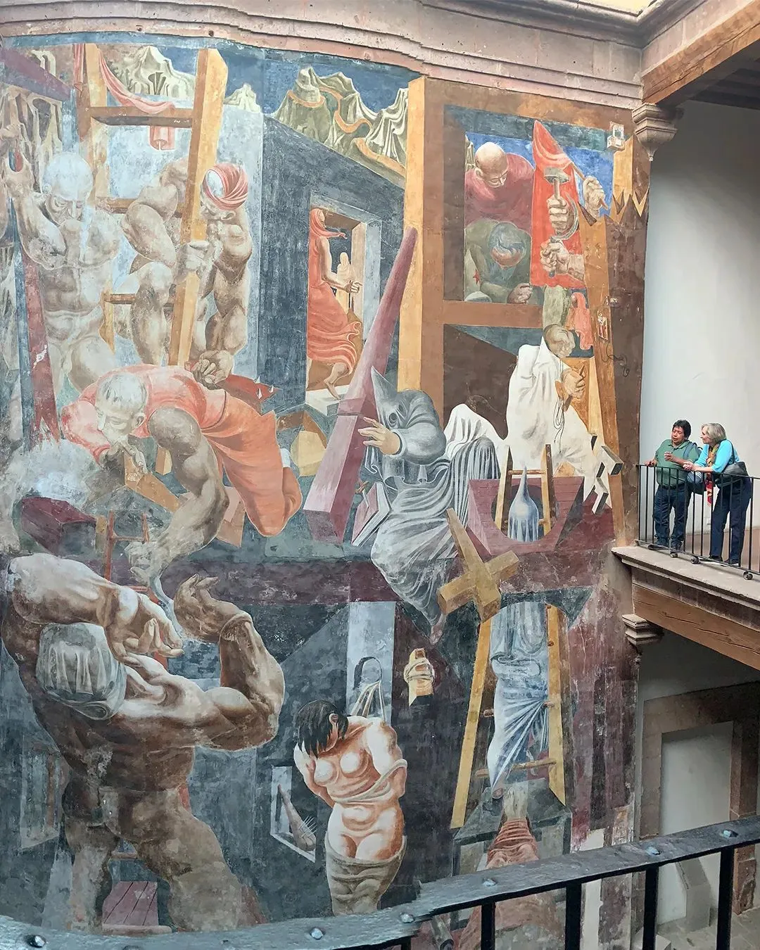 The Struggle Against Terrorism, 1935 before restoration (in 2022) from the balcony, with Sally Radic Executive Director The Guston Foundation and Jacopo Garcia Cruz, Institute of Mural Conservation, Ministry of Culture, Mexico City, Photo: Thomas May