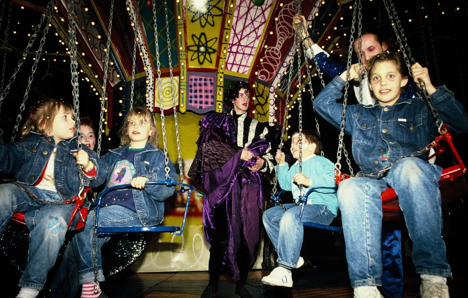 Visitors on Kenny Scharf’s painted chair swing ride. Luna Luna, Hamburg, Germany, 1987