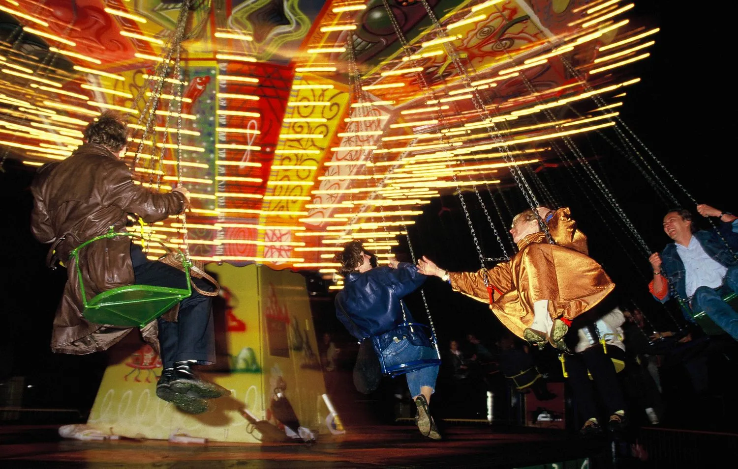 Visitors on Kenny Scharf’s painted chair swing ride. Luna Luna, Hamburg, Germany, 1987